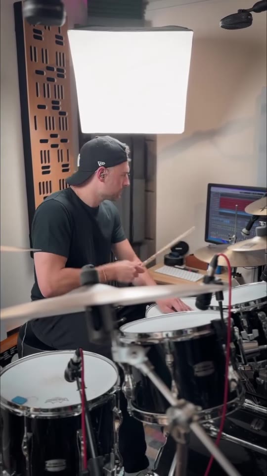Max Saidi playing drums in his studio