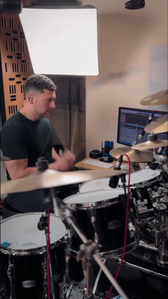 Max Saidi playing drums in his studio